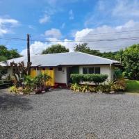 a small white house with a gravel driveway at Mapusaga Riverside Apartments Sleeps 6, Vaitele