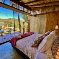 a bedroom with a bed and a balcony with a table at Alma de Campo Glamping - Laguna de Suesca