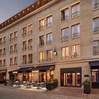a large building with tables and chairs in front of it at La Caserne Chanzy Hotel & Spa, Autograph Collection, Reims
