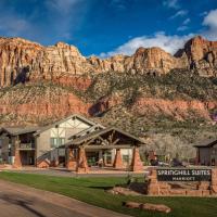 a hotel with a mountain in the background at SpringHill Suites by Marriott Springdale Zion National Park