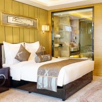 a hotel room with a large bed and a couch at Pullman Wuxi New Lake
