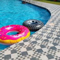 a donut and a tire in a swimming pool at Mona chalet "Families only" عائلات فقط, Al Khīrān