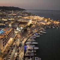a harbor with boats in the water at night at Strada Marina Hotel, Zakynthos