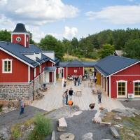 a group of people standing in front of a red building at Hotel Nestor & Restaurant Back Pocket, Korppoo