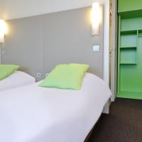 a room with two beds and a green door at Campanile Villeneuve-Sur-Lot, Villeneuve-sur-Lot