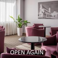 a waiting room with purple chairs and a table at OREA Hotel Voro Brno