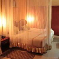 a hotel room with a bed and a desk at Dolce Vita Resort Hotel, Bujumbura