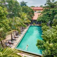 an overhead view of a swimming pool with chairs and trees at Plantation Urban Resort & Spa, Phnom Penh