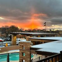 a rainbow in the sky over a building with a pool at El Sendero Inn, Ascend Hotel Collection, Santa Fe