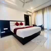 a bedroom with a large bed with red pillows at Hotel Horizon Hues, Port Blair