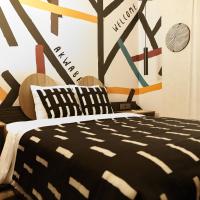 a bedroom with a bed with a black and white blanket at ONOMO Hotel Abidjan