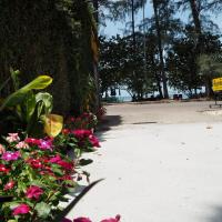 a bunch of flowers on the side of a sidewalk at Pakmeng Beach Resort, Pak Meng