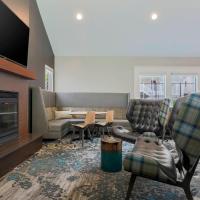 a living room with two chairs and a fireplace at Residence Inn Boston North Shore/Danvers