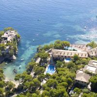 an aerial view of a resort on the water at Hotel Petit Cala Fornells, Paguera