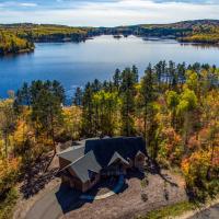 an aerial view of a house on the shore of a lake at Lakefront Giants Ridge Retreat Near Ski and Golf!, Biwabik