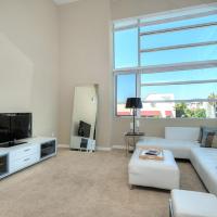 a living room with a white couch and a flat screen tv at Awesome 2 bedroom 2 Bathroom, Los Angeles