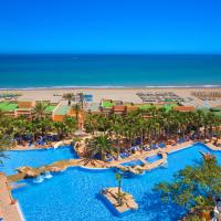 an aerial view of a resort with a pool and a beach at Playacapricho Hotel, Roquetas de Mar