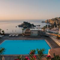 a swimming pool with a view of the ocean at Taormina Panoramic Hotel