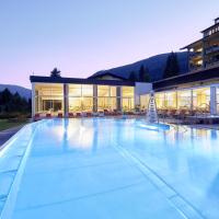 a large swimming pool in front of a building at Das Ronacher Therme & Spa Resort, Bad Kleinkirchheim