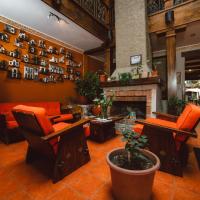 a lobby with orange chairs and a fireplace at Gran Hotel París, Cuenca