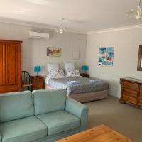 a living room with a couch and a bed at Bentworth Lodge, Carramar