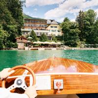 a person driving a boat in the water at Landhaus zu Appesbach, St. Wolfgang