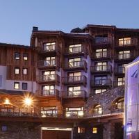 a large building with a sign on the side of it at Hôtel Koh-I Nor by Les Etincelles, Val Thorens