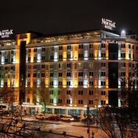 a large building with lights on it at night at New Park Hotel, Ankara