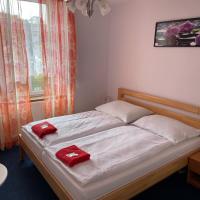 a bedroom with a bed with red towels on it at Hotel V Pivovaře Davle