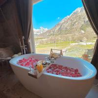 a bath tub with a view of a mountain at Bujtina Miqesia, Theth