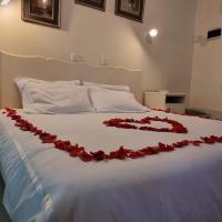 a bed with a red rose decoration on it at Neat standard room in guesthouse - 2088, Bulawayo