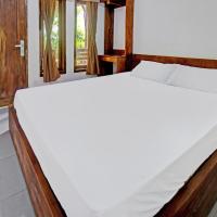 a large white bed in a room with a window at OYO 92275 Tastura Homestay, Praya