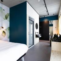 a bedroom with a white bed and a blue wall at the urban hotel Moloko - rooms only - unmanned - digital key by email, Enschede