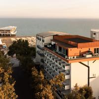 an aerial view of a building with the ocean in the background at Hotel Lampara, Lignano Sabbiadoro