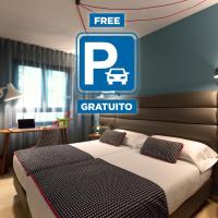 a hotel room with a bed and a free parking sign at Hotel Pamplona Plaza