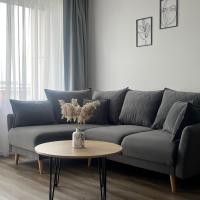a living room with a couch and a table at Saules apartamentai, Klaipėda