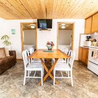 a kitchen and living room with a wooden table and chairs at Terimore Lodging by the Sea, Tillamook