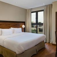 a hotel room with a large bed and a desk at Protea Hotel by Marriott Ikeja Select