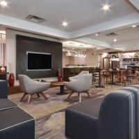 a hotel lobby with chairs and a dining room at Courtyard by Marriott Charlotte Lake Norman, Huntersville