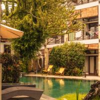 a swimming pool in front of a building at Ecosfera Hotel, Yoga & Spa, Canggu