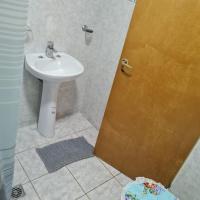 a bathroom with a toilet and a sink at Doña juanita, Los Antiguos