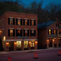 a street with two brick buildings with lights in the windows at Riverboat Suites, Galena