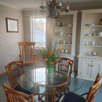 a dining room with a glass table and chairs at Vinegar Hill Airbnb, Bridgetown
