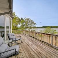 a porch with chairs and a view of the water at Serene Lakefront Mountain Home Getaway with Atrium!