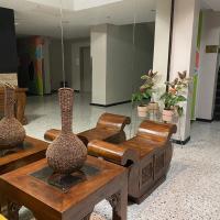 a living room with two vases on a table and chairs at U-wey Dragons Hotel, Rockhampton