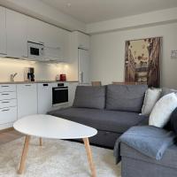 a living room with a couch and a table at Uusi kaksio Kaarinan keskustassa