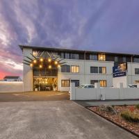 a large white building with a parking lot at JetPark Hotel Rotorua