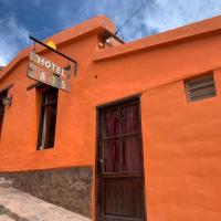an orange building with a sign above a door at Cactus Hostel, Purmamarca