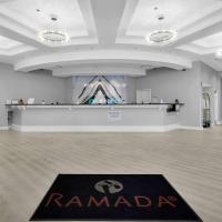 a large room with a rug in the middle of it at Ramada by Wyndham Jacksonville I-95 by Butler Blvd