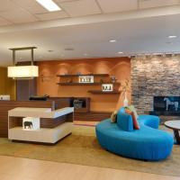 a living room with a blue couch and a fireplace at Fairfield Inn & Suites by Marriott Columbus Dublin